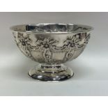 An attractive embossed silver sugar bowl decorated