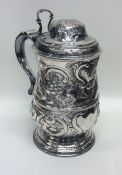 A good chased George III silver lidded tankard pro