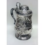 A good chased George III silver lidded tankard pro