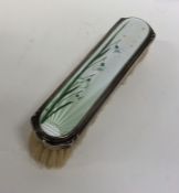 A small attractive silver and enamelled brush deco