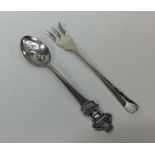 A novelty Rolex teaspoon together with a silver pi