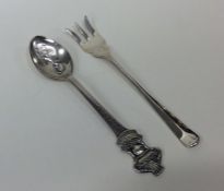 A novelty Rolex teaspoon together with a silver pi