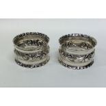 A pair of Edwardian silver embossed napkin rings.