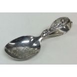 An unusual silver child's feeding spoon engraved w