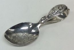 An unusual silver child's feeding spoon engraved w