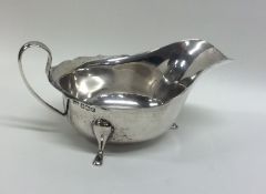 An Edwardian silver sauce boat with shaped edge. S