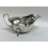 An Edwardian silver sauce boat with shaped edge. S