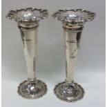 A good pair of cast silver spill vases with pierce