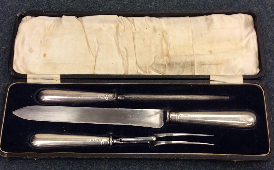 A cased silver handled three piece carving set. Sh