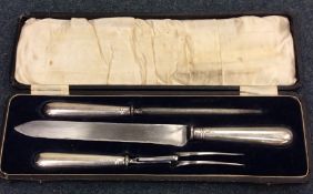 A cased silver handled three piece carving set. Sh