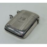 A heavy engine turned silver vesta case with hinge