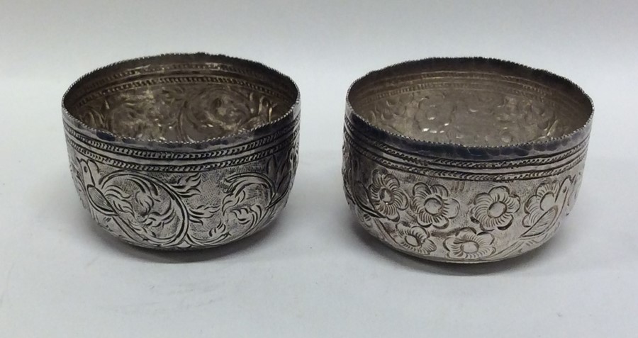 A pair of Indian silver circular bowls with emboss