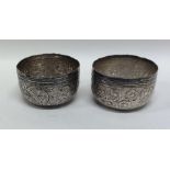 A pair of Indian silver circular bowls with emboss