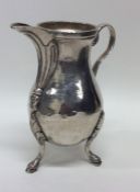 An 18th Century Continental silver jug on three ha