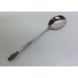 A silver and silver gilt spoon with pineapple fini