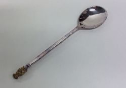 A silver and silver gilt spoon with pineapple fini