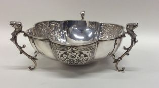 A heavy silver three handled bonbon dish with flor