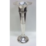 A tall silver tapering spill vase with shaped edge