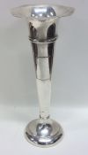 A tall silver tapering spill vase with shaped edge