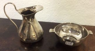 A small silver quaich together with a cream jug. A