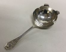 A heavy Edwardian silver tea strainer with pierced