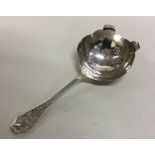 A heavy Edwardian silver tea strainer with pierced