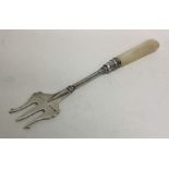 An silver and MOP pickle fork with engraved decora