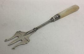 An silver and MOP pickle fork with engraved decora