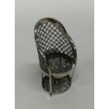 A miniature Chinese model of a chair. Marked to ba