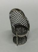 A miniature Chinese model of a chair. Marked to ba