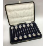 A rare set of twelve bean top silver coffee spoons