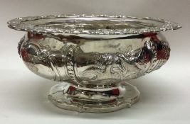 A heavy Georgian silver sugar bowl profusely decor