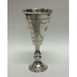 A large tapering etched silver goblet on pedestal