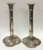 A pair of unusual George III silver candlesticks.