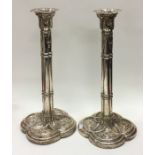 A pair of unusual George III silver candlesticks.
