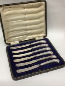 A boxed set of six silver pistol handled knives. E