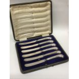 A boxed set of six silver pistol handled knives. E