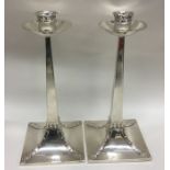 A pair of Arts & Crafts tapering candlesticks with