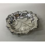 A novelty silver pin dish in the form of a leaf. B