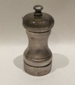 A 20th Century silver pepper grinder of typical fo