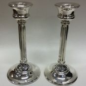 A pair of circular stylish silver candlesticks. Bi