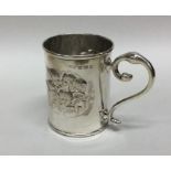 A decorative silver christening cup embossed with