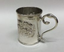 A decorative silver christening cup embossed with