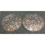 A pair of heavy silver and glass mounted trivets d