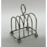 An Edwardian silver five bar toast rack on ball fe