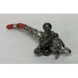 A large silver child's rattle / whistle mounted wi