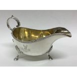 A crested silver sauce boat with beaded rim. Londo