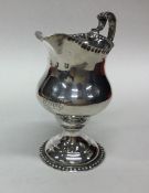 A George III silver g=cream jug with textured bord