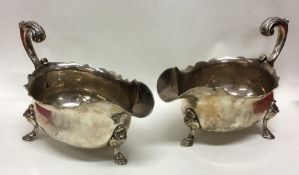 A pair of Georgian silver sauce boats with card cu