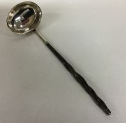 A George III silver toddy ladle with whalebone han